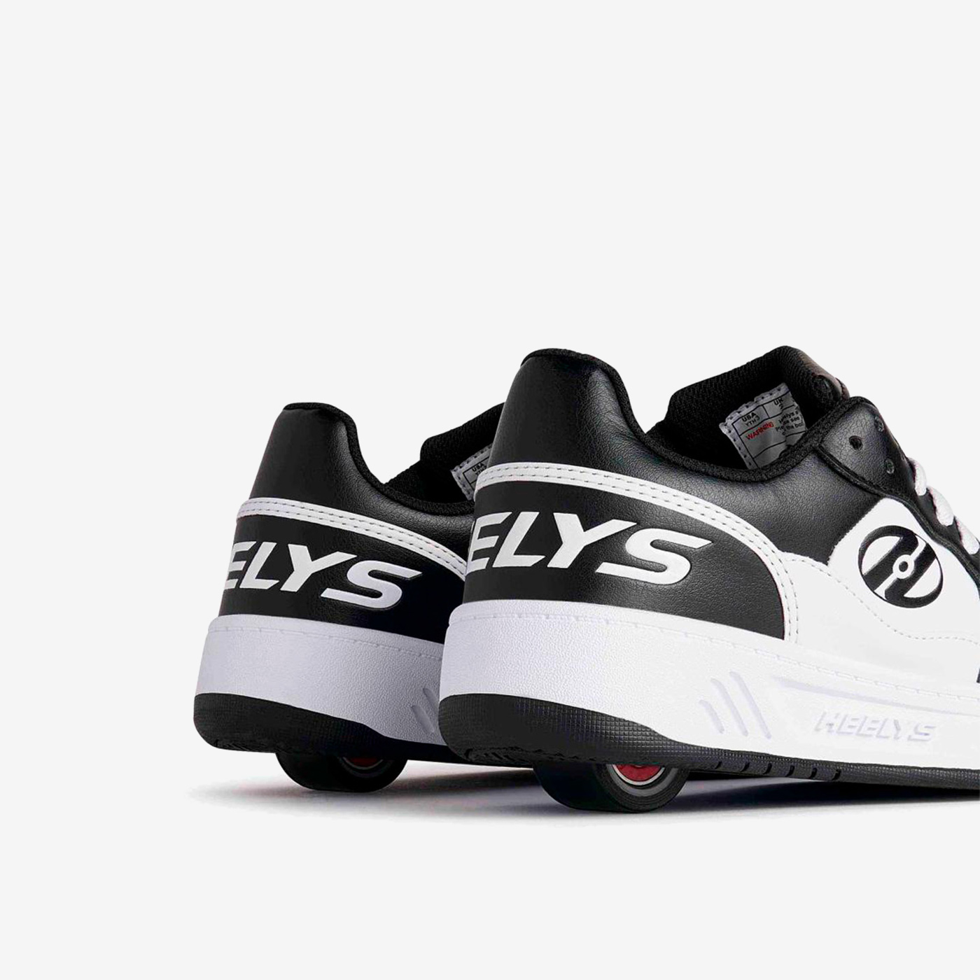 Heelys blancas y negras de rueda con cordones.